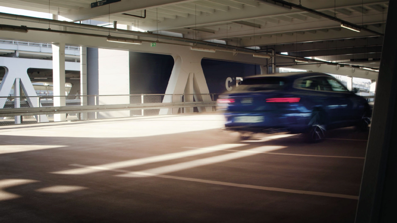 An Arteon R Shooting Brake driving through a car park