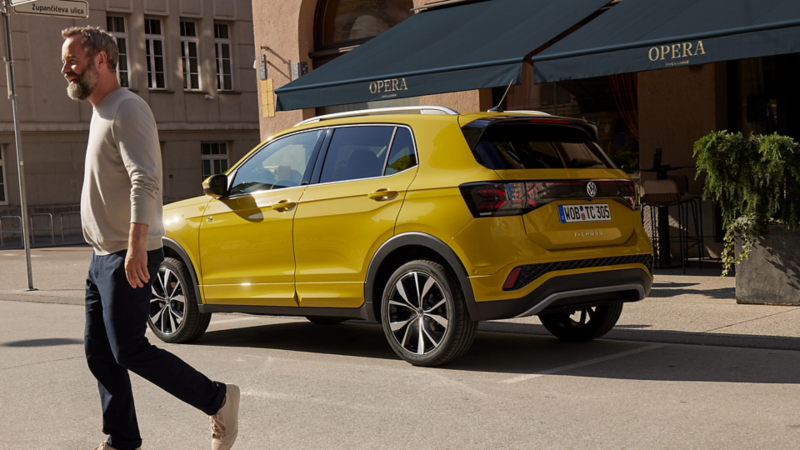 A man walking away from a yellow T-Cross