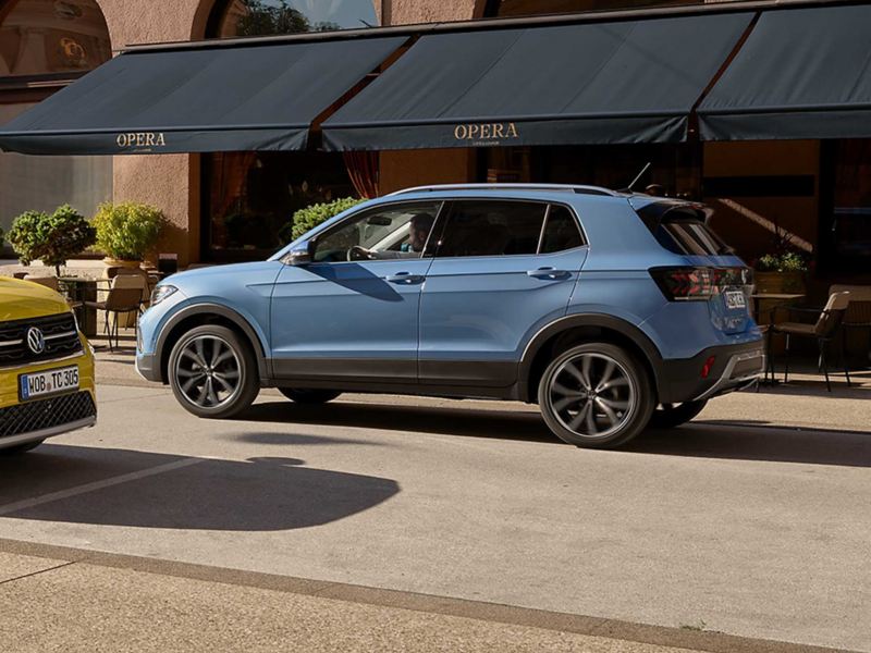 A blue T-Cross parked outside a restaurant