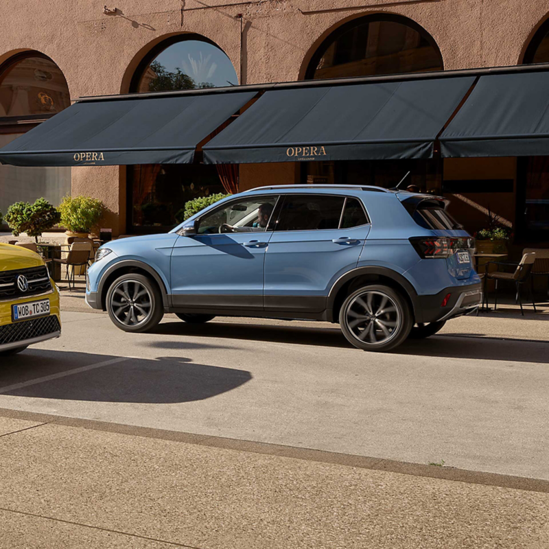 A blue T-Cross parked outside a restaurant