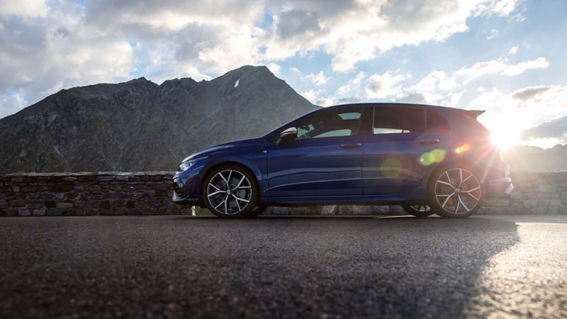 A Golf R parked in front of mountains