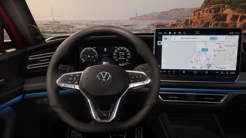 Detailed view of the dashboard in a VW Tiguan with a view out to sea through the front windscreen
