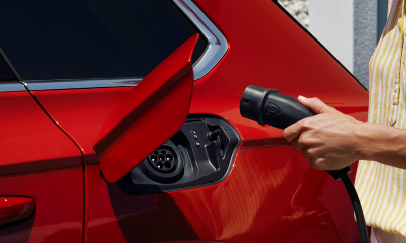A man plugging in a charger into a VW Touareg