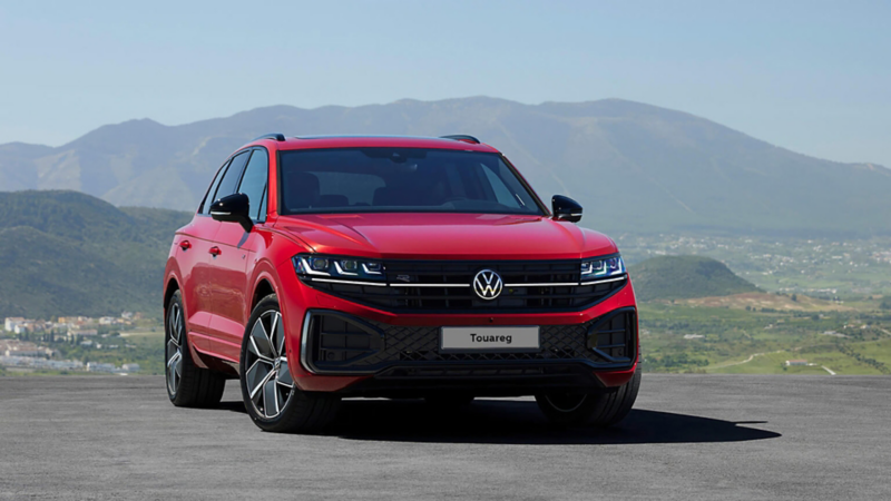 New Touareg Black edition in red parked near mountain
