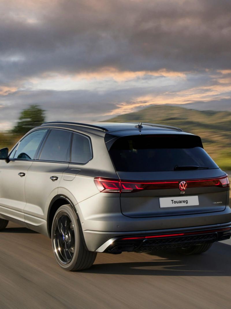 View of the Touareg R eHybrid from the rear driving down a mountain road