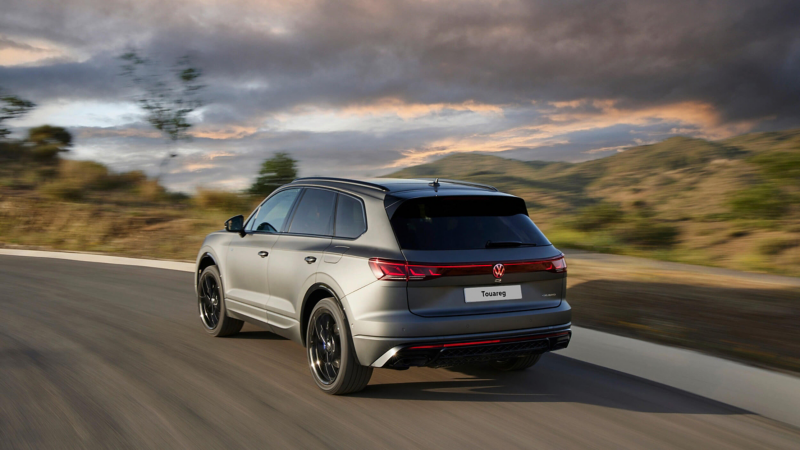 View of the Touareg R eHybrid from the rear driving down a mountain road