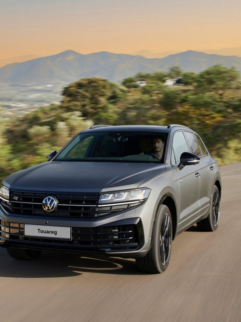 View of the Touareg R eHybrid from the front driving down a mountain road