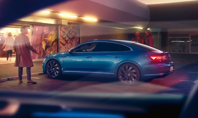 A man stood outside a parked new Arteon