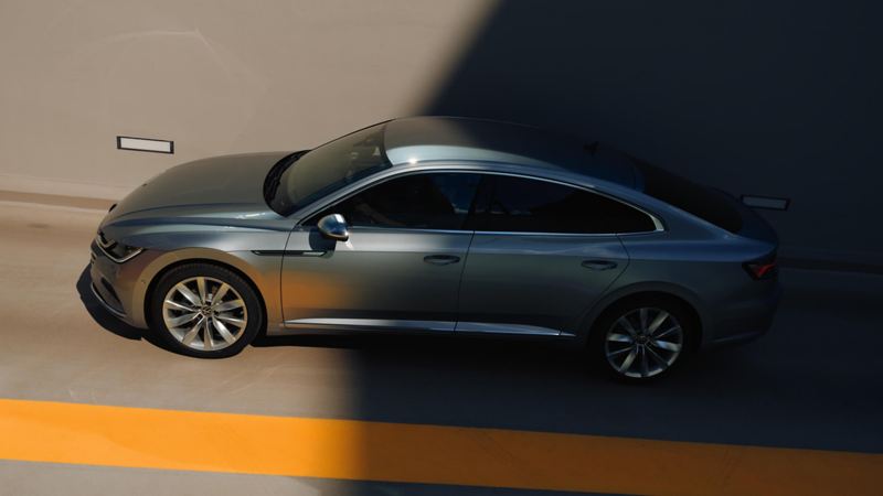 VW Arteon Hybrid drives past at the side