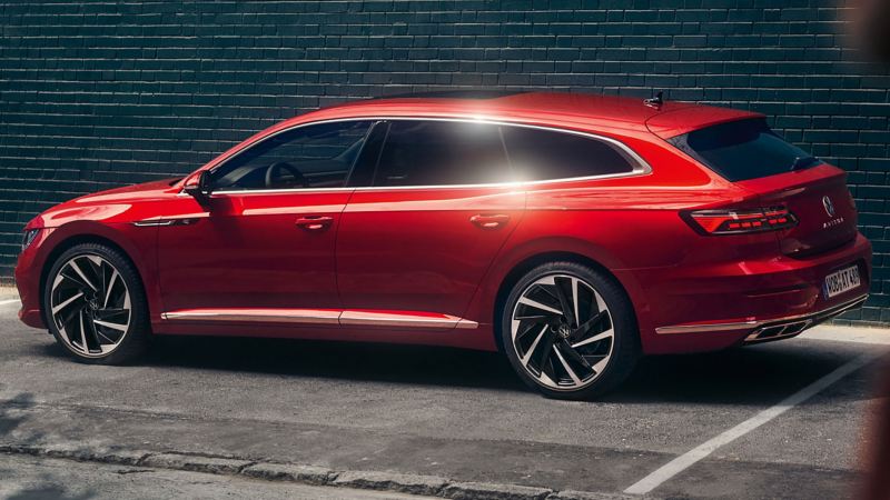 A red Arteon Shooting Brake parked against a wall