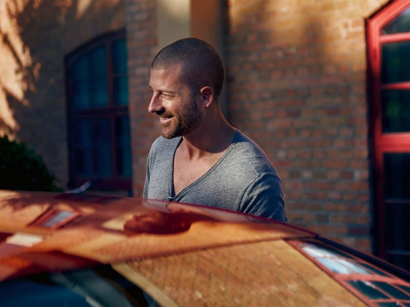 A man stood outside of his car