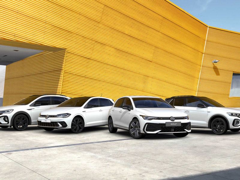 Image showing a range of Black Edition trims parked outside a modern office building. 