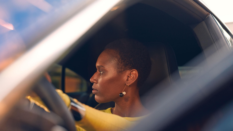 A woman sits at the steering wheel of her Volkswagen Arteon R