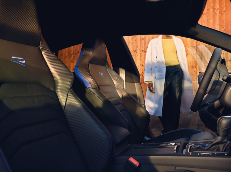 A woman entering a VW car