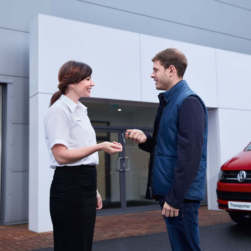 A Volkswagen retailer handing over the car keys to a customer
