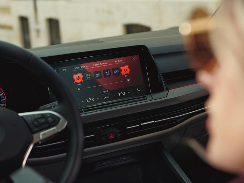Interior shot of a Volkswagen Golf 8, steering wheel and dashboard.