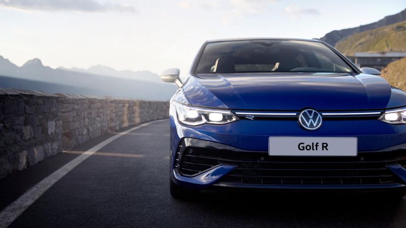 The new Golf R on a mountain road, seen from the front. Mountains are in the background.