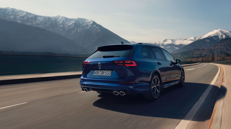 The VW Golf R Estate in Lapiz Blue driving along a mountain road