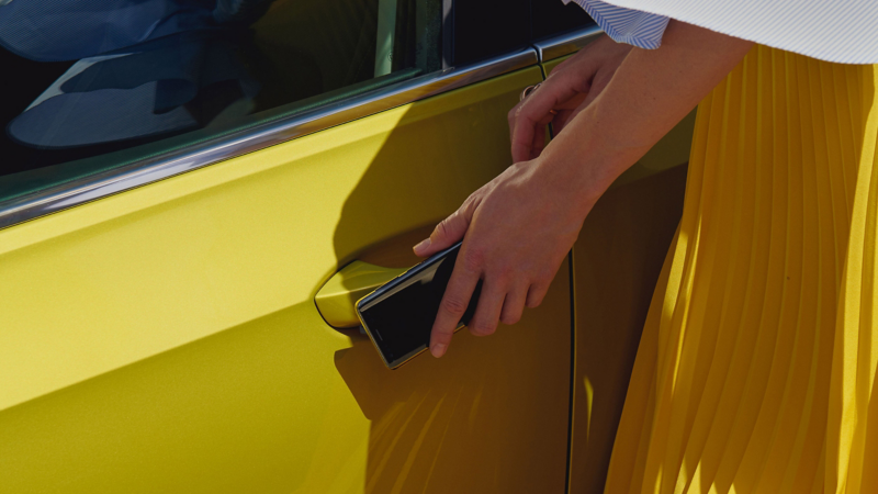 A woman opening the door of a Golf GTD