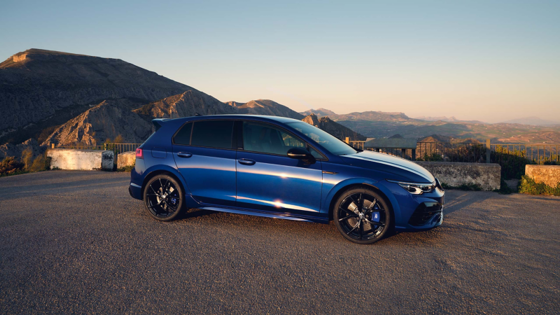 A Golf R 20 Years parked in front of mountains