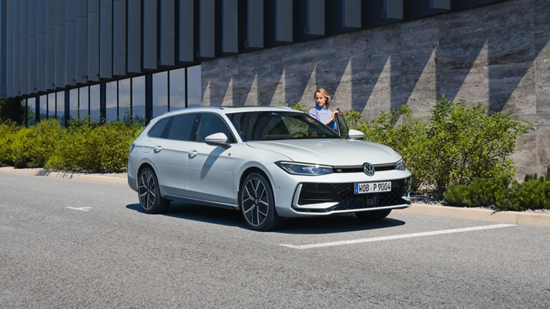 A person getting into a silver Passat eHybrid