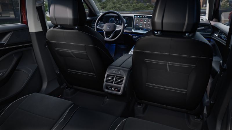 From the right rear seat, we look at the backs of the front seats with the climate control for the second-row passengers and into the Passat's cockpit.