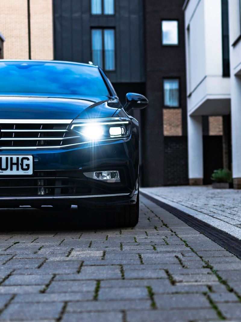 Front view from the ground of a Volkswagen Passat Estate with the lights on