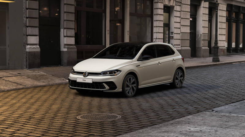 exterior front 3/4 shot of a Polo black edition parked on a cobbled street