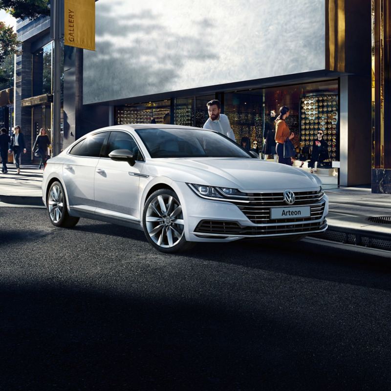 A man getting out of a white arteon