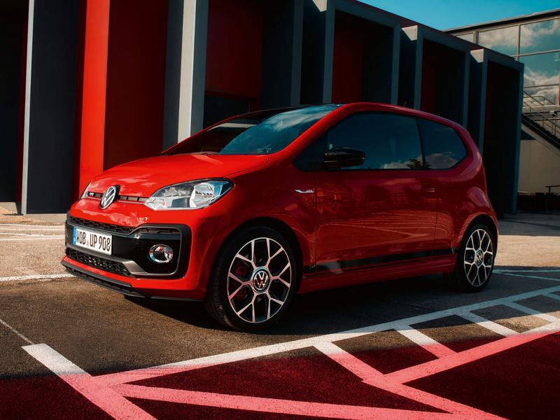 A red Volkswagen up! GTI parked 
