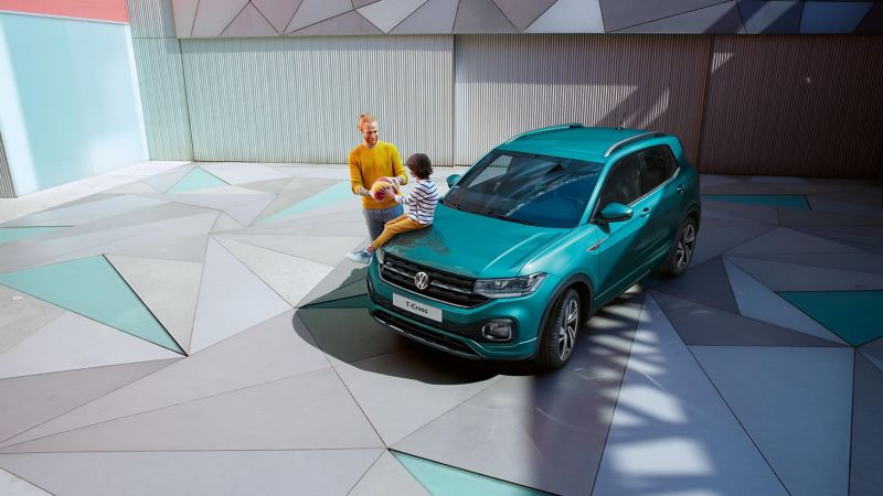 The VW T-Cross parked on a driveway with a father and son playing with a basketball