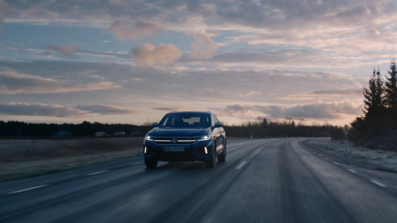 A blue VW T-Roc R driving down a motorway