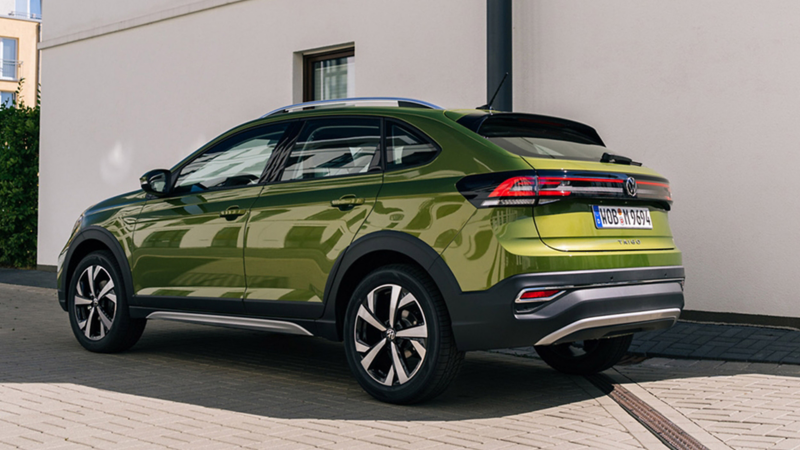Green Taigo parked in front of a white wall