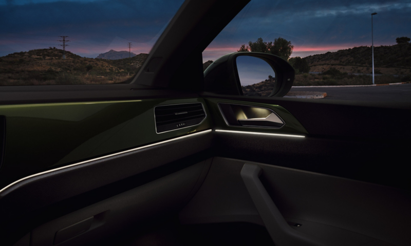 VW Taigo interior view of the dashboard with the ambient lighting switched on