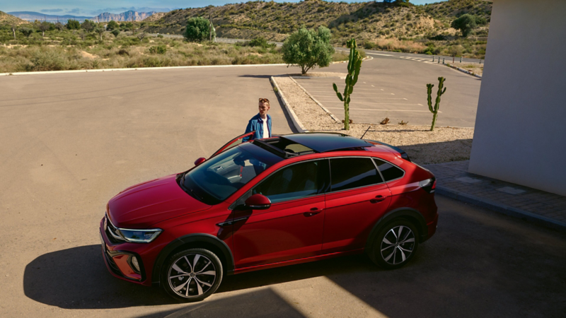 A high up view of a red VW Taigo with the sunroof open