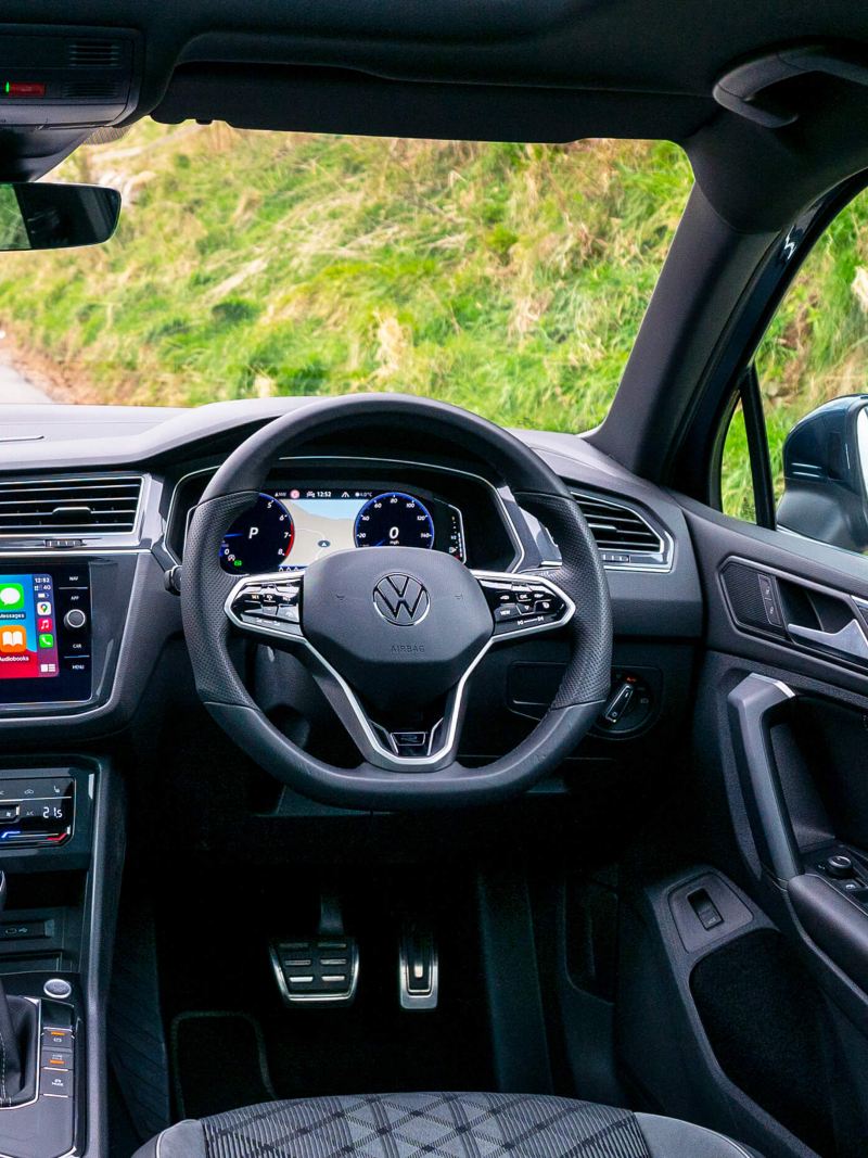 An interior shot of the VW Tiguan cockpit showing infotainment system
