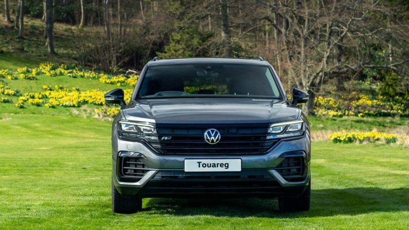 A front shot of a Touareg parked in a field 
