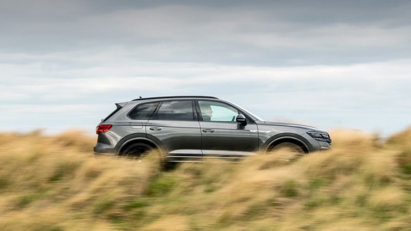 A Touareg parked in a field with long grass