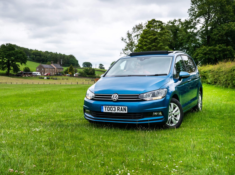 Volkswagen Touran parked in a field