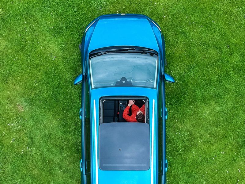 The interor of a Volkswagen Touran with the panoramic glass sunroof in focus