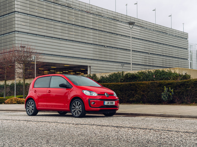 Front view of a parked red VW up on trading estate