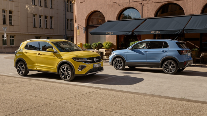 yellow and blue T-Cross parked outside a shop on a street