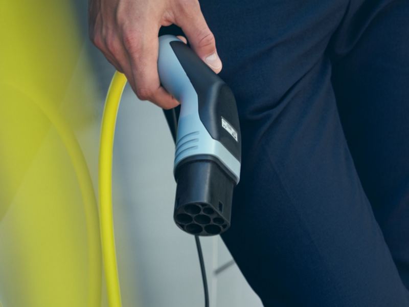 customer holding a eletric vehicle charging plug