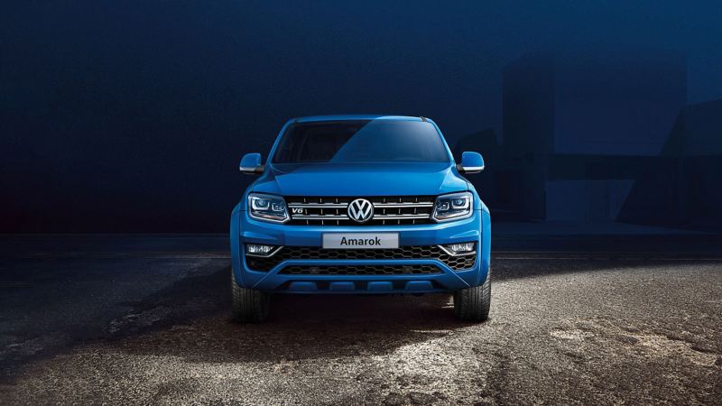 Blue VW amarok parked on gravel