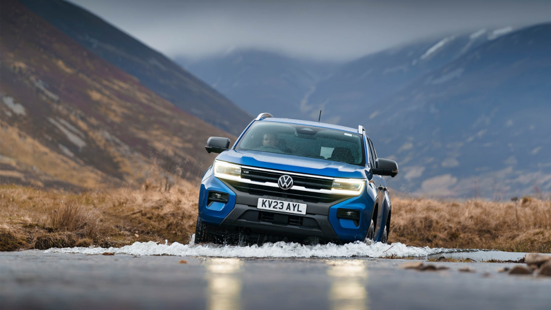 a blue Amarok on driving through some water demonstrating the off-roading capability of the vehicle