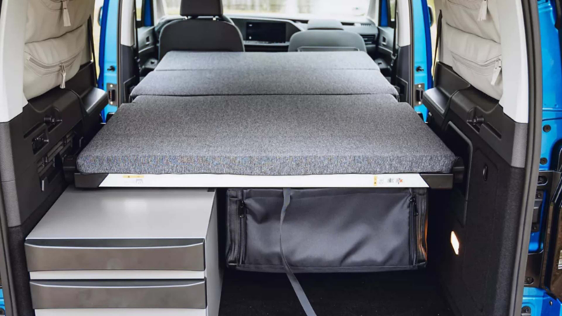 California 6.1 interior showing the seats and fold away table with food on it.