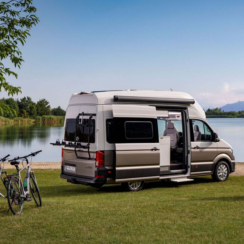 a Grand California parked by a lake 