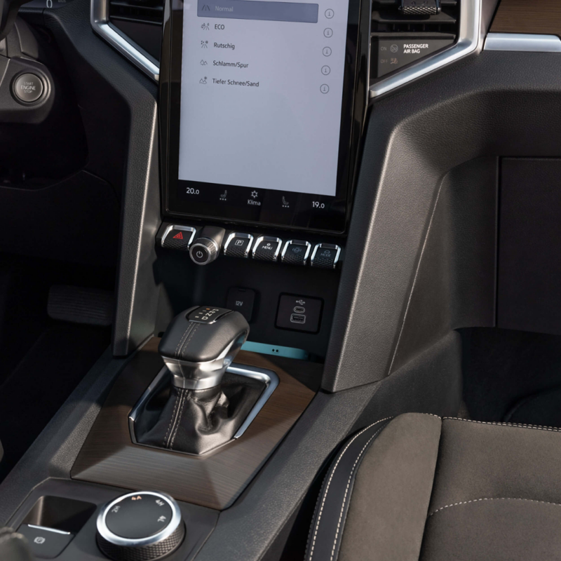 Interior shot of a VW Amarok cockpit showing a close of the gear stick and display screen module.