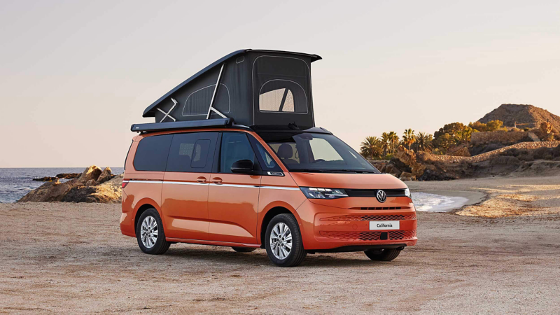 Photo showing an orange California parked on a beach.