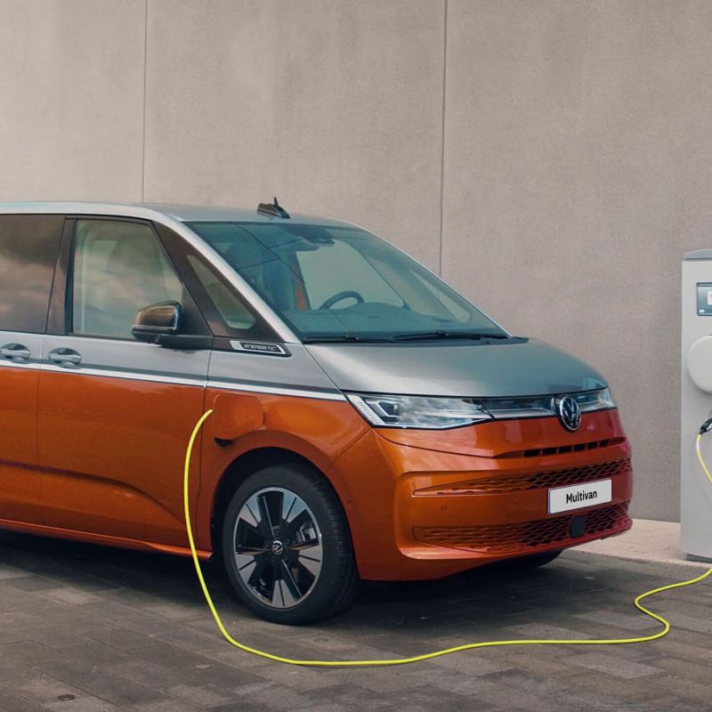 A VW Multivan plugged into charger